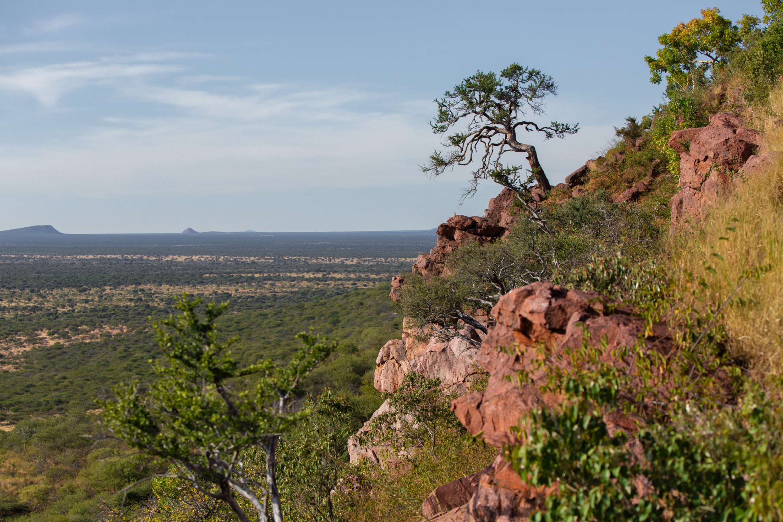 Rocky outcrop view over the Omboroko Mountains and surrounding plains