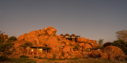 Luxury safari lodge perched atop the red boulders of the Namibian landscape