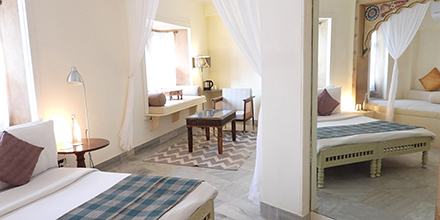 Bright heritage suite at The Stepwell House featuring hand-crafted furniture and soft furnishings.