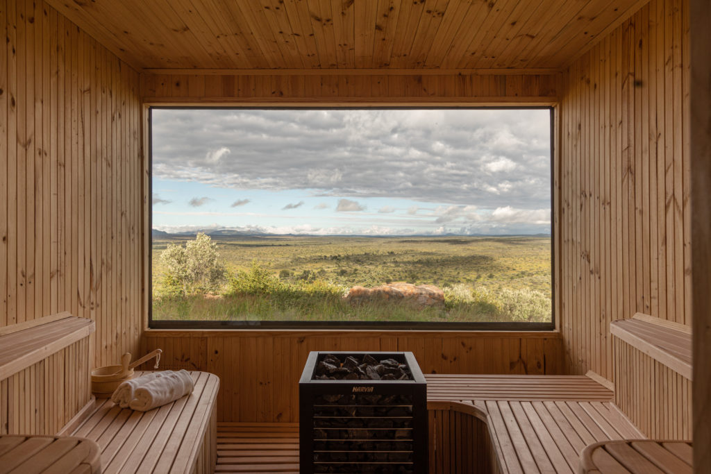 Timber sauna with panoramic window overlooking the Kalahari landscape