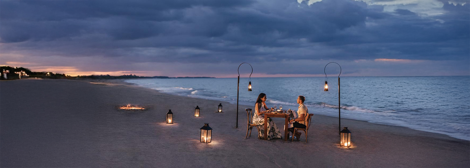 Couple enjoy a romantic dinner on a Sri Lankan beach