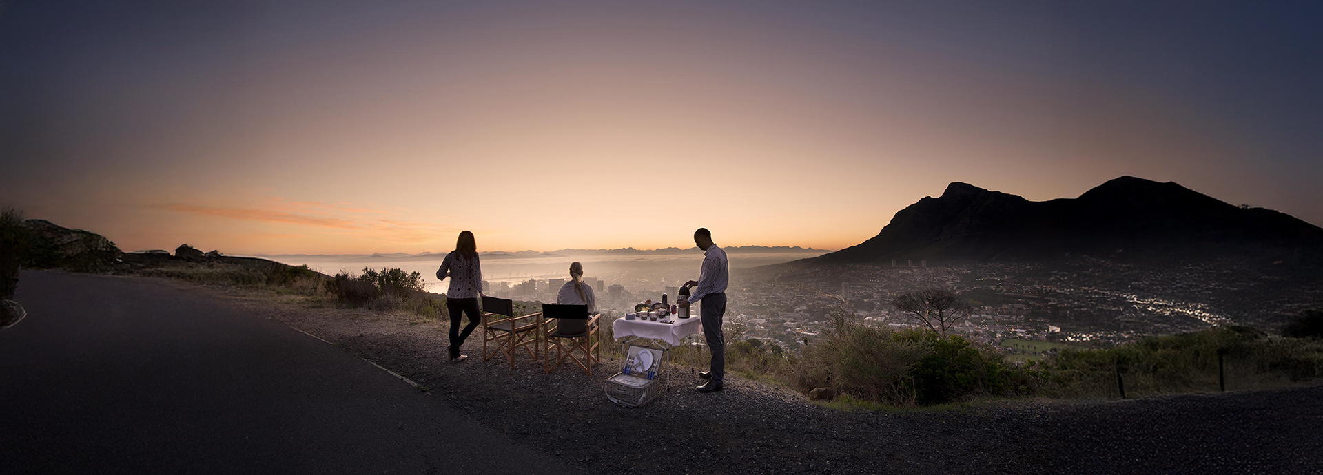 People enjoying a sunset picnic overlooking Cape Town