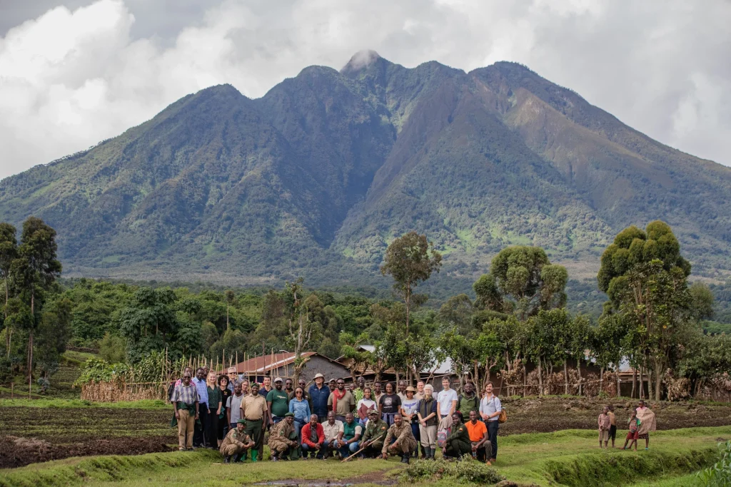 Group of conservationists, rangers and community members gathered beneath Mount Sabyinyo in the Virunga Mountains