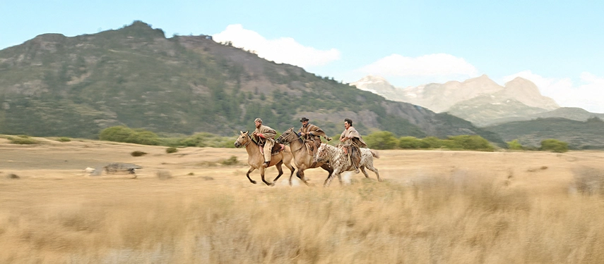 Argentine gauchos riding across the golden plains of Patagonia, celebrating the enduring horsemanship culture of the southern pampas.