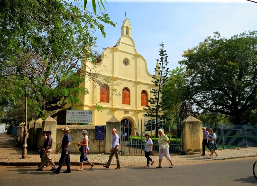 Visitors stroll past the sublime St Francis Church, a historic Fort Kochi landmark near the hotel.