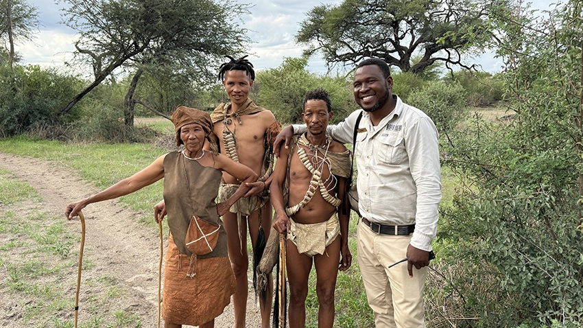 San tribespeople pause for a photo with a safari guide in Makgadikgadi Pans National Park. 