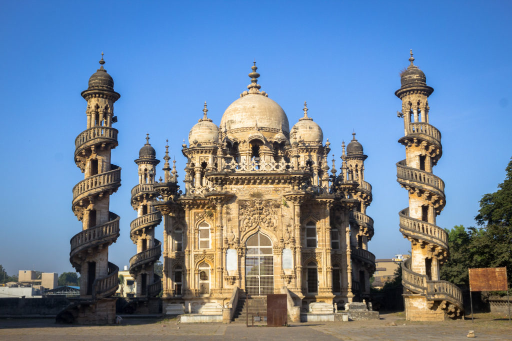 Ornate spiral-staircase minarets and domed facade of Mahabat Maqbara, Junagadh