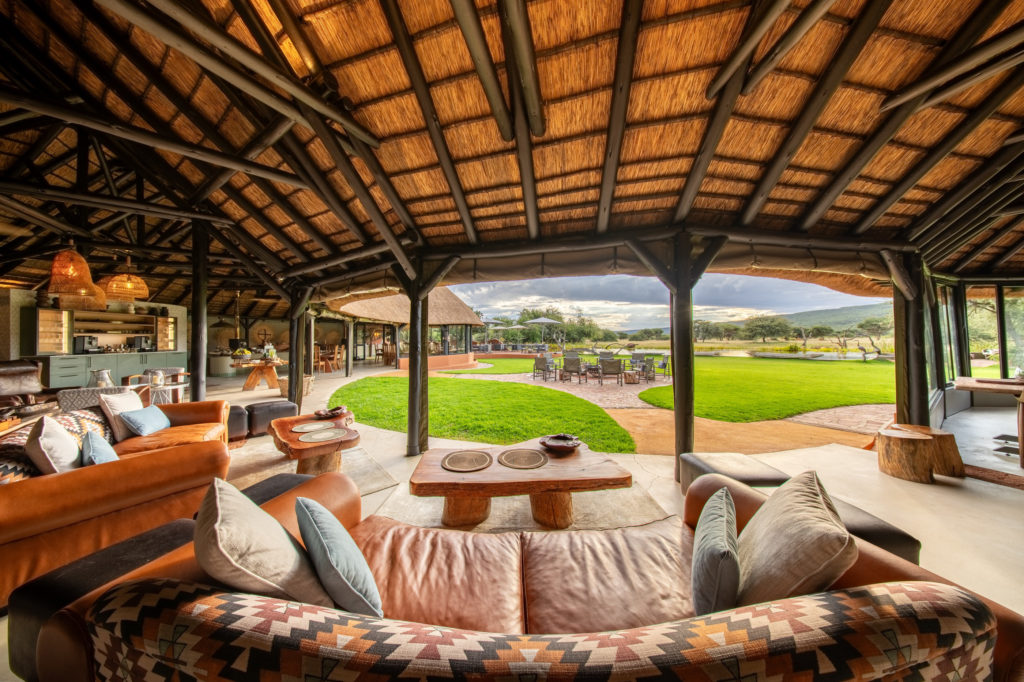 Main lapa lounge and dining area at Okonjima Luxury Bush Camp overlooking the lawn