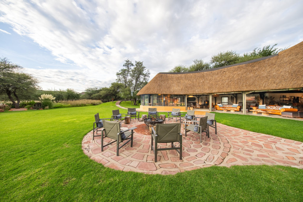 Fire pit seating area on the lawn at Okonjima Luxury Bush Camp