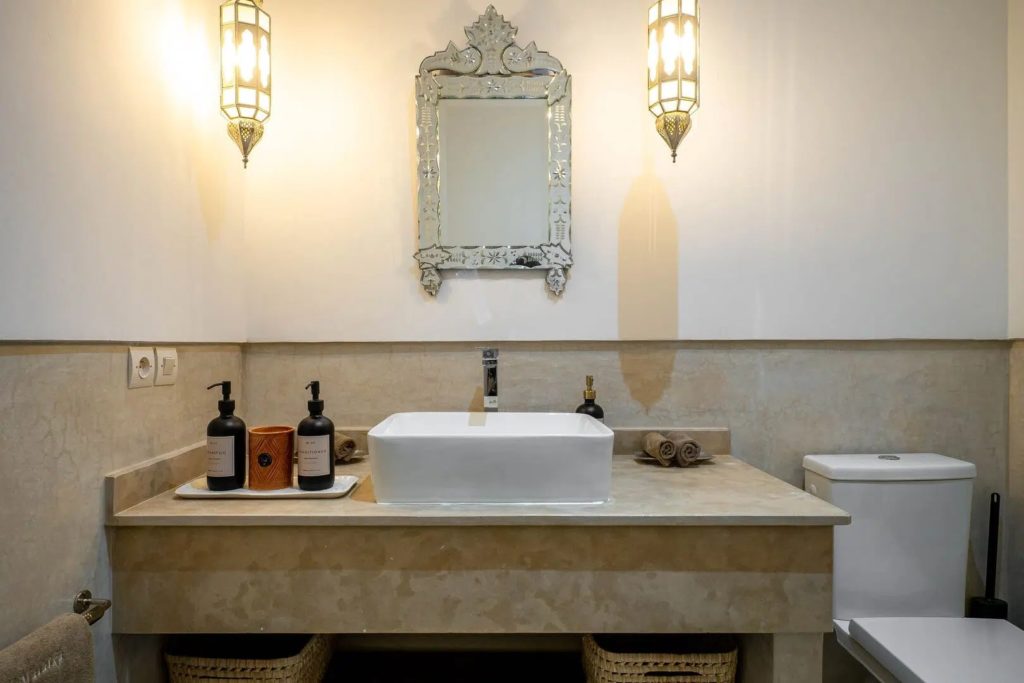 Bathroom vanity with vessel sink, Venetian mirror & Moroccan lantern sconces