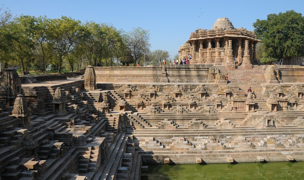 The historic stepwell and sun temple complex at Modhera, near Nalsarovar, in golden afternoon light.