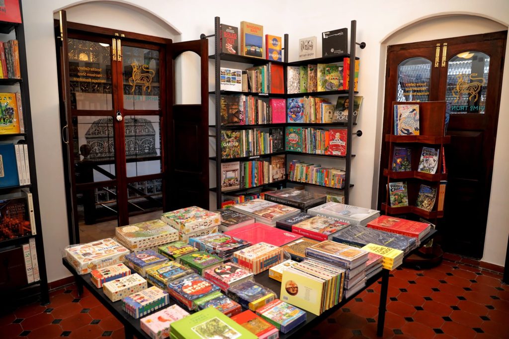 Shelves of art, design and children's books fill a cosy corner of the hotel's heritage bookstore, with carved wooden doors leading outside.