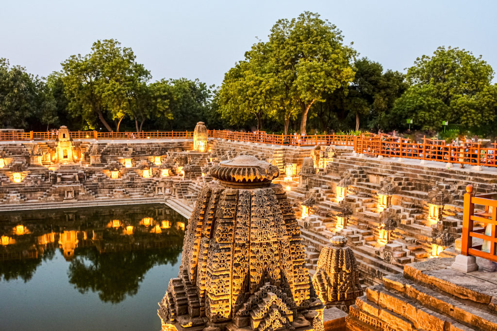 Carved stepped tank illuminated at dusk at the Sun Temple, Modhera