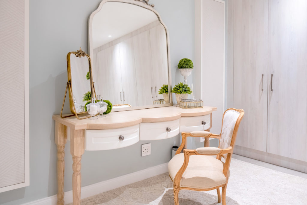 Dressing table at The Weinberg with ornate mirror and upholstered armchair