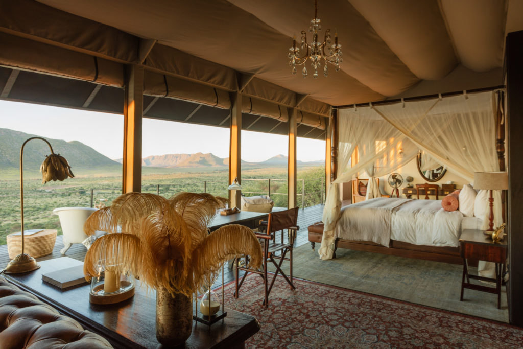 Ostrich feather displays and antique lamps decorate a suite's writing desk
