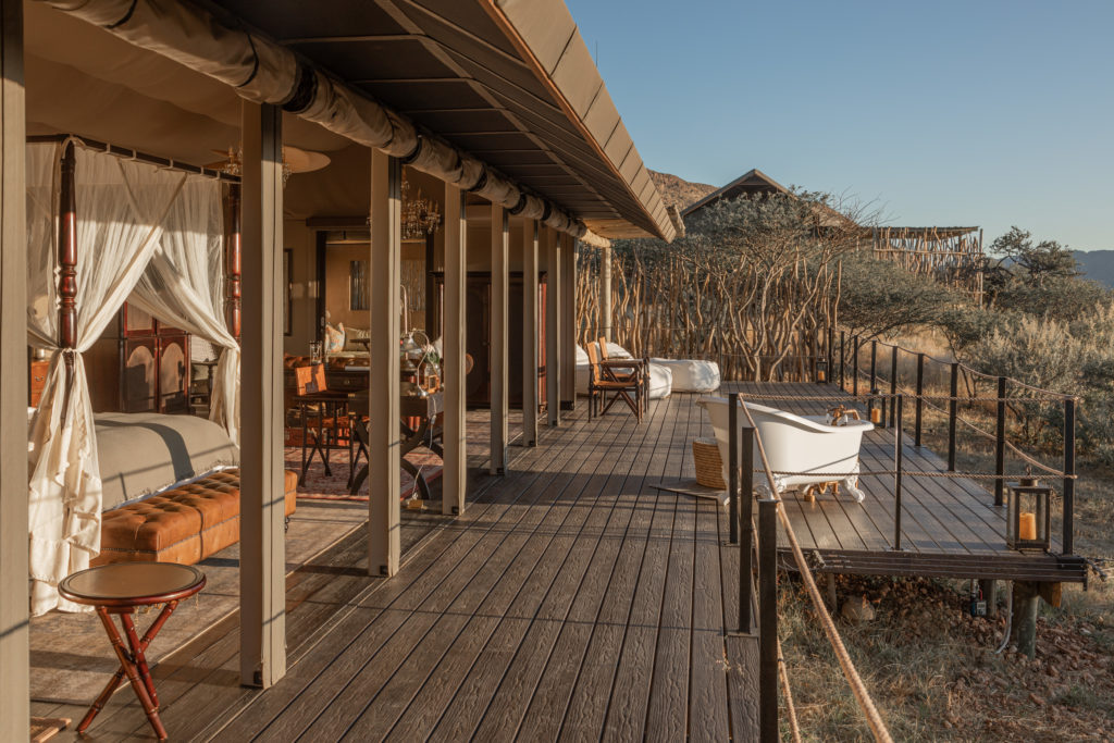 A four-poster bed and freestanding outdoor bathtub sit beneath the suite's private deck