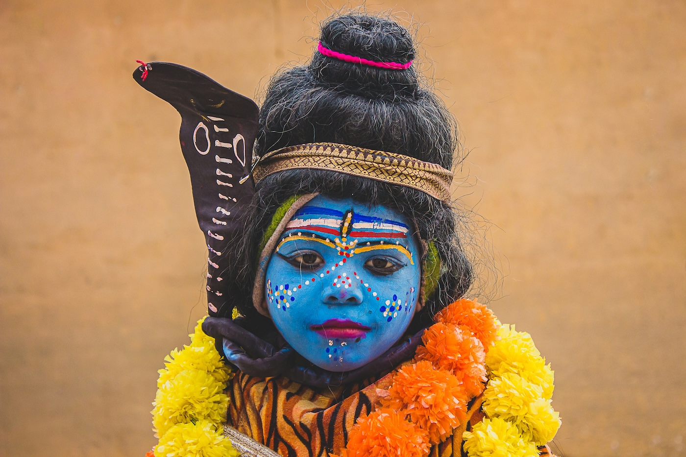 Girl dressed in blue face paint in honour of Vishnu for the Janmashtami festival, Celebrations of India