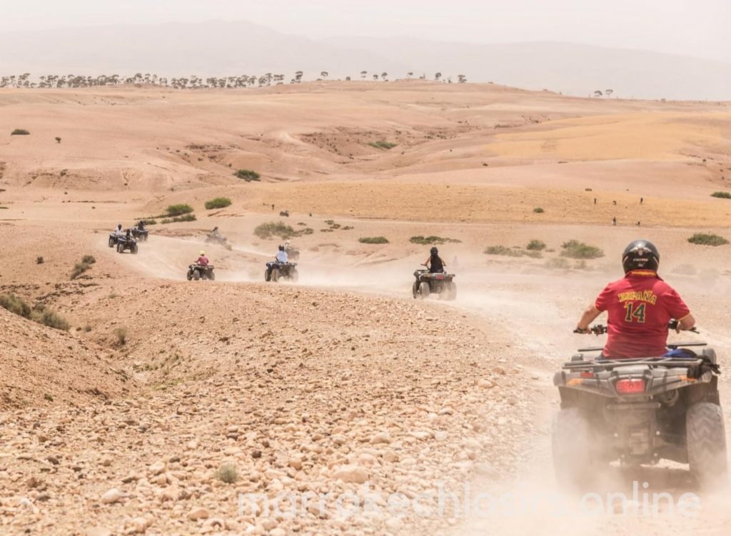 A line of quad bikes kicks up dust across the stony Agafay terrain.