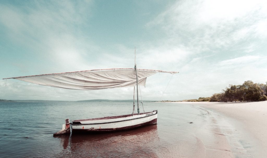 A traditional sailing boat lies on a deserted beach in the Bazaruto Archipelago in Mozambique. 