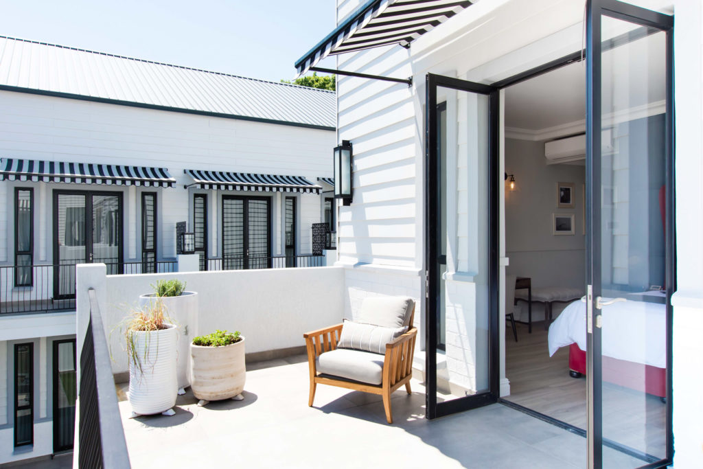 Terrace Suite balcony at The Weinberg with armchair and potted plants overlooking the guest rooms below