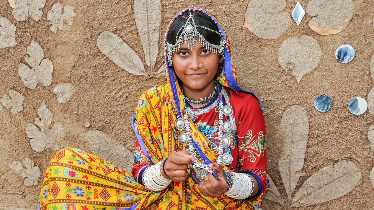 A young Kutch woman in traditional embroidered dress and silver jewellery